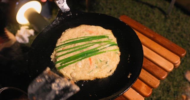 Preparing Savory Korean pancake on a Hot Skillet