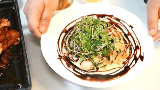 Table with stir-fried pork on hot plate and cream shrimp