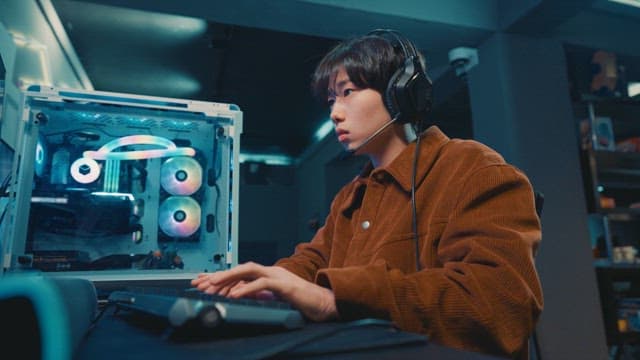 Young adult using a computer in a gaming cafe