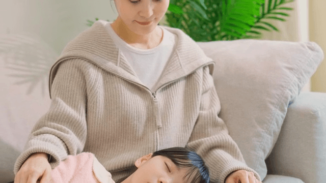 Child sleeping on a woman's lap