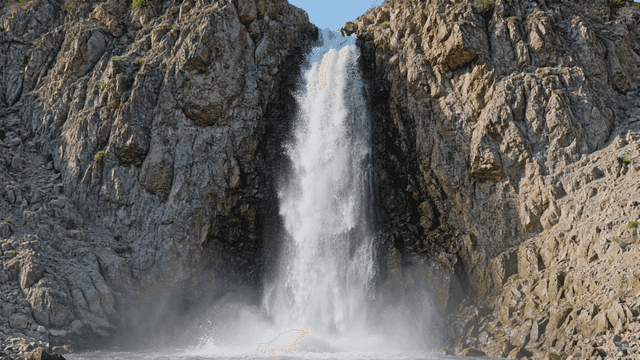Waterfall falling along rocky cliff