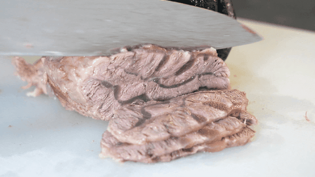 Scene of cutting beef on cutting board