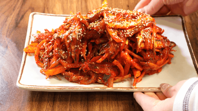 Spicy raw anchovy salad sprinkled with sesame seeds