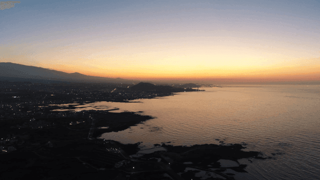 Sunset over a coastal cityscape