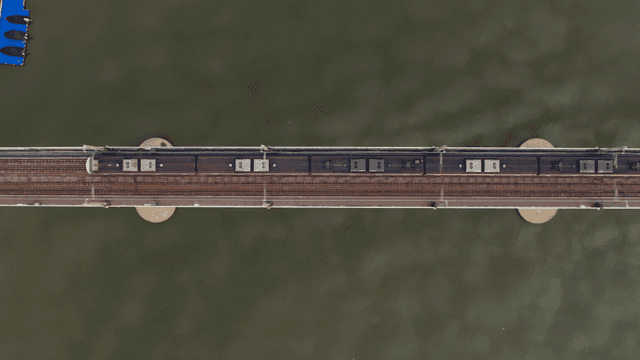 Train crossing a bridge over a river