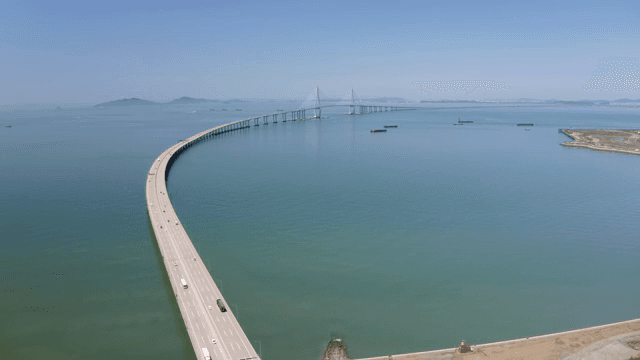 Long bridge stretching over calm sea