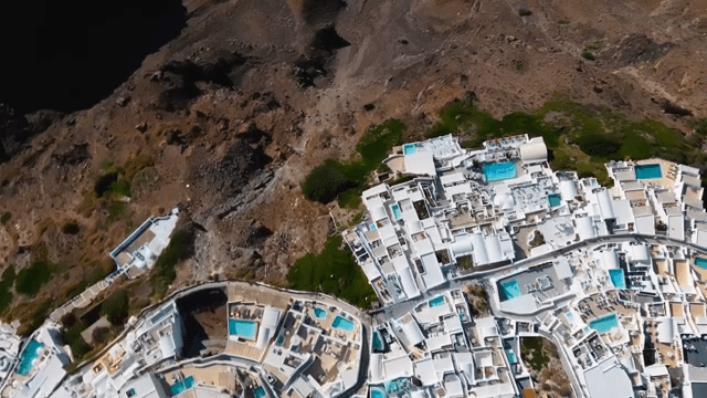 Aerial view of a coastal village with white buildings