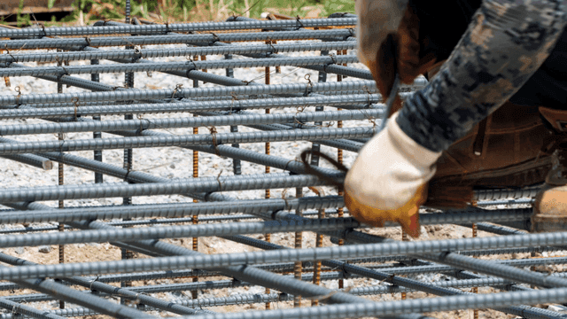 Worker tying rebar at a construction site