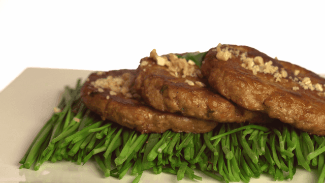 Grilled tteokgalbi on top of chives