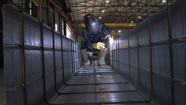 Worker welding inside a metal structure