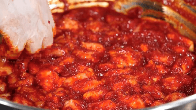Beef large intestines mixed with seasoning in a bowl