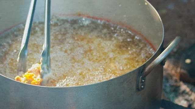 냄비에서 뜨거운 기름에 튀겨지는 생선튀김