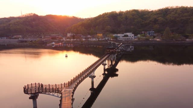 Scenic bridge over a calm river at sunset