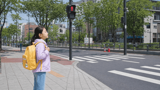 Girl waiting at crosswalk