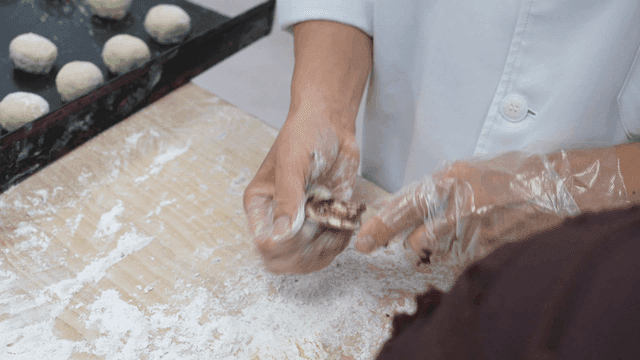 Hands preparing dough with filling