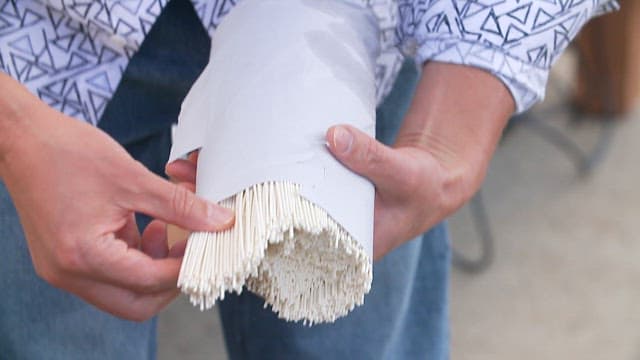 Putting noodles into a pot of boiling water