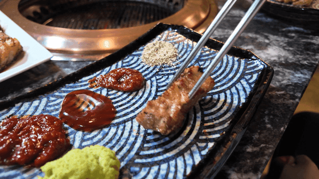 Grilled pork belly with various sauces in Korean barbecue
