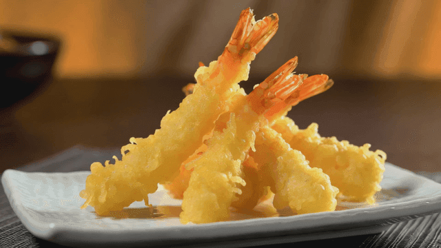 Crispy shrimp tempura on a white plate