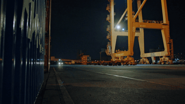 Night view of a shipping port with cranes