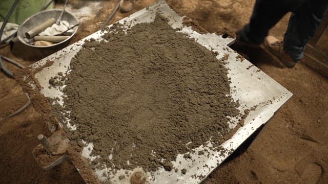 Workers handling sand molds in a factory