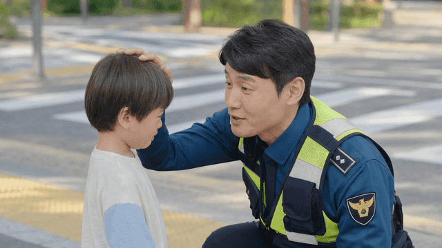 Police officer comforting child at crosswalk