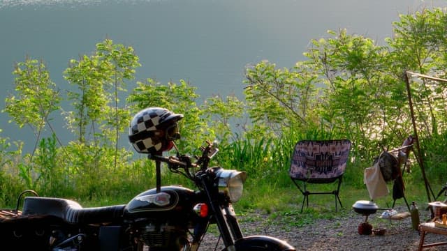 Motorcycle by the lake with camping gear