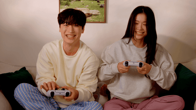 Couple enjoying console video game on sofa