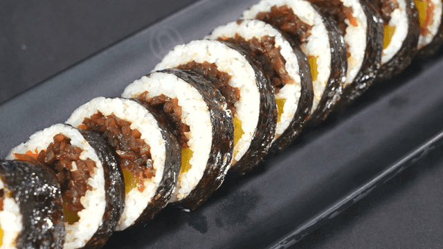 Kimbap slices neatly arranged on a plate