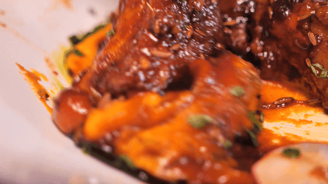 Seasoned ribs with rich herb-infused sauce