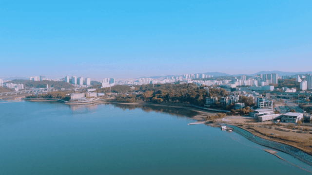 A cityscape with a river and buildings