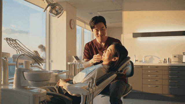 Dentist examining patient lying in dental chair