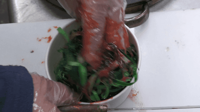 Mixing seasoned seaweed in a bowl