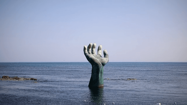 Large hand sculpture in the sea