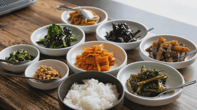 Various Korean side dishes on table