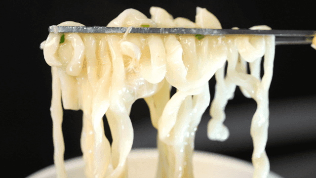 Chopsticks lifting chicken kalguksu noodles