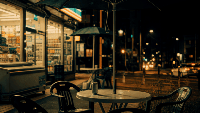 Night view of a convenience store with outdoor seating