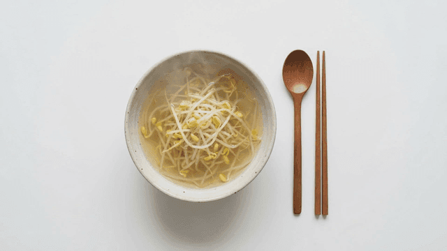 Hot bean sprout soup placed with spoon