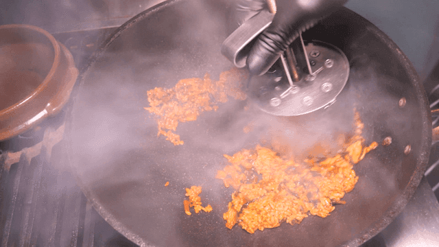 Kimchi fried rice steaming in pan