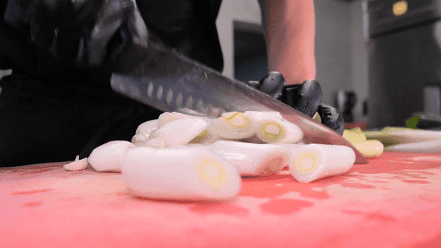 Chopping green onions on a cutting board
