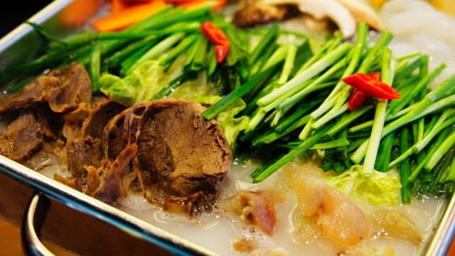 Boiling tendon hotpot with vegetables and meat in a pot