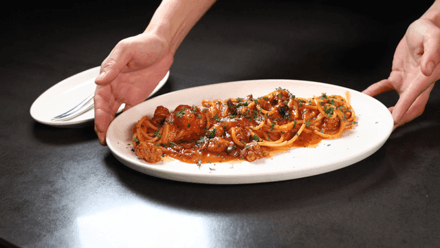 A plate of spaghetti with tomato sauce