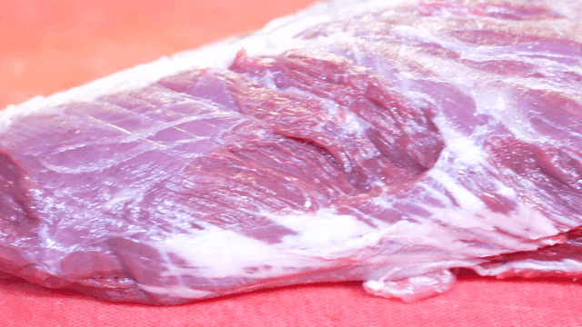 Fresh raw meat on red cutting board