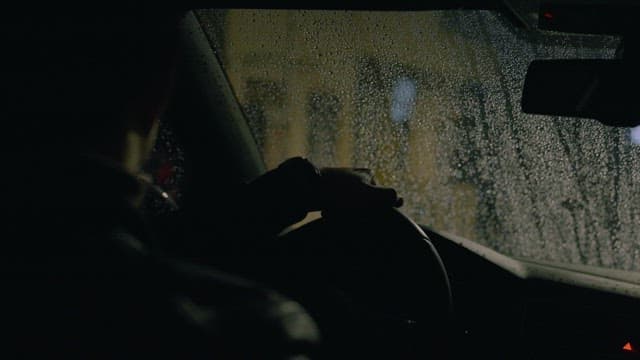 Driver Starting His Car on a Rainy Night