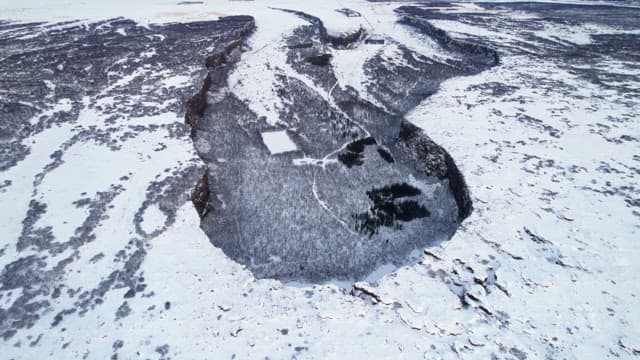 Snow-covered landscape with cliffs