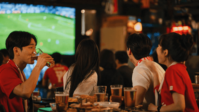Friends enjoying soccer match at pub