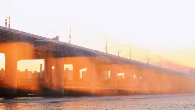 Water fountain on a bridge during sunset