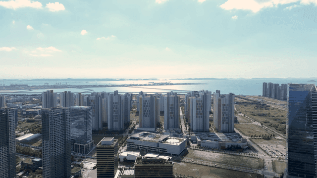 Modern cityscape with high-rise buildings overlooking the sea