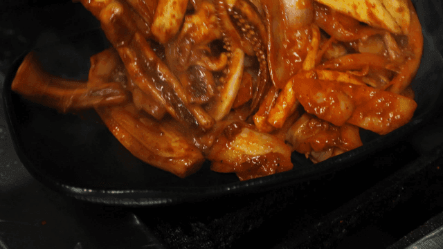 Spicy stir-fried squid being cooked