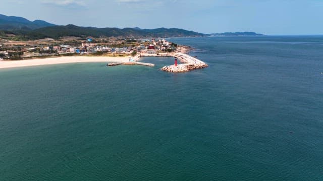 Coastal town with a lighthouse and pier