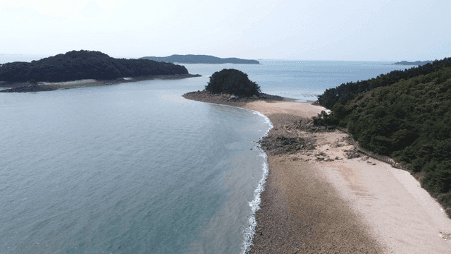 Quiet beach with island visible in distance